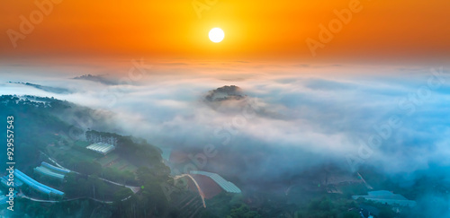 Aerial view of Xuan Tho suburbs near Da Lat city at morning with misty and sunrise sky. This place is considered most beautiful and peaceful place to watch sunrise in highlands of Vietnam photo