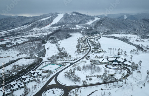 Daegwallyeong Pass, Yongsan-ri, Pyeongchang-gun, Gangwon-do, South Korea - March 20, 2022: Aerial view of snow covered road and buildings at Alpensia Resort in winter photo