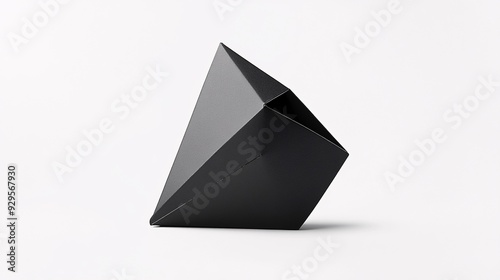 A chic, modern product package with a bold, geometric design. The package is made of thick, matte black cardboard and features a striking, triangular shape. The white label is placed asymmetrically photo