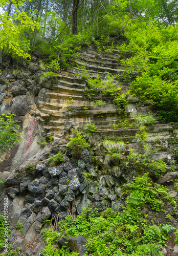 Jilin Province, China - June 22, 2019: Low angle view of volcanic rocks and horizontal columnar joint at Mangcheona Valley of Baekdusan Mountain in summer photo