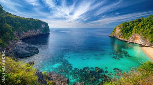 A secluded bay in Phuket at midday, with the sun shining brightly from a clear blue sky