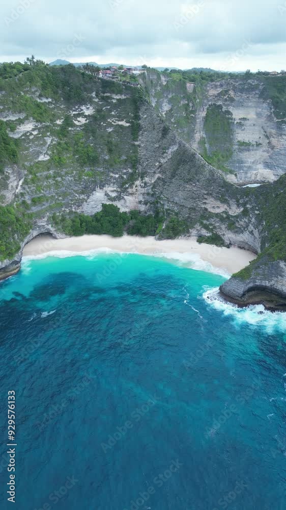 Kelingking Beach on Bali's Penida Island offers a spectacular aerial view of its cliffside charm. Kelingking Beach on Bali's Penida Island offers a spectacular aerial view of its cliffside charm.
