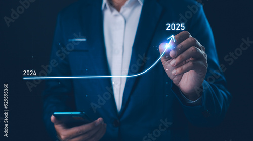 Obraz na płótnie 2024 to 2025 business financial plan market concept, performance of profit growth on 2024, education trend up finance on growth graph money revenue, Businessman analyzes profitability of working. w salonie