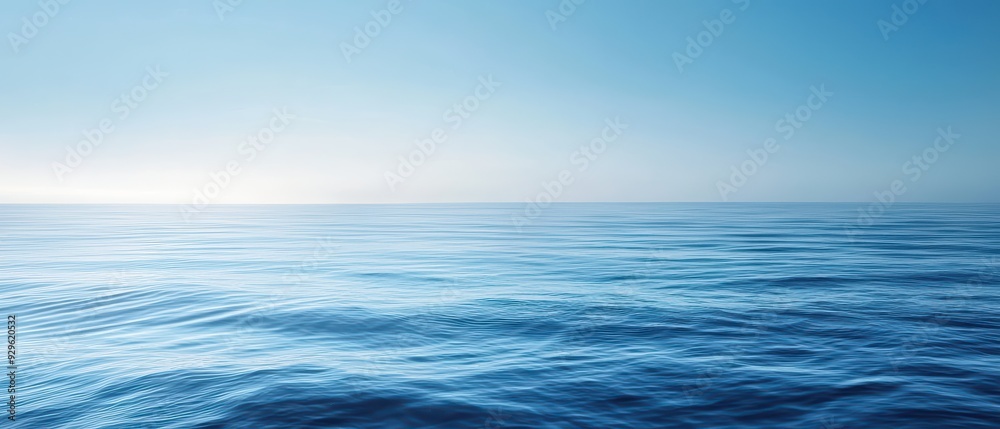 Fototapeta premium A tranquil blue ocean scene with soft waves and a clear sky