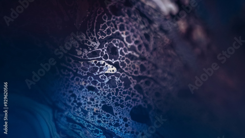 Fizzy fluid. Bubble paint. Defocused blue purple color oil texture gasoline liquid mix on dark abstract art background.