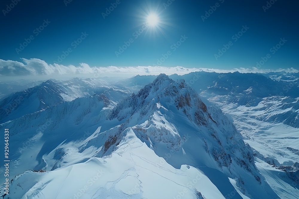 Majestic landscape of a large snow-capped, sharply pointed mountain covered in snow on a clear day, with a strong wind blowing the snow. Majestic landscape of a large snow-capped, sharply pointed mountain covered in snow on a clear day, with a strong wind blowing the snow.