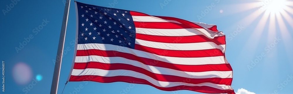 American flag waving against a clear blue sky, symbolizing patriotism, pride, seasonal relevance for July 4th, copy space for texts. American flag waving against a clear blue sky, symbolizing patriotism, pride, seasonal relevance for July 4th, copy space for texts.