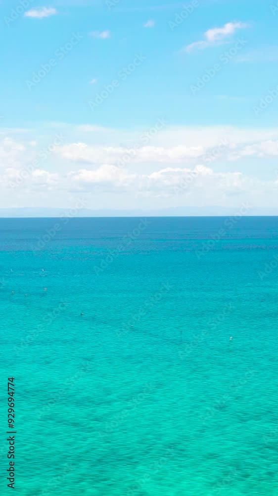 Sea surface with corals and turquoise clear waters. Blue sky and clouds. Seascape. Bantayan, Cebu, Philippines. Vertical view. Sea surface with corals and turquoise clear waters. Blue sky and clouds. Seascape. Bantayan, Cebu, Philippines. Vertical view.