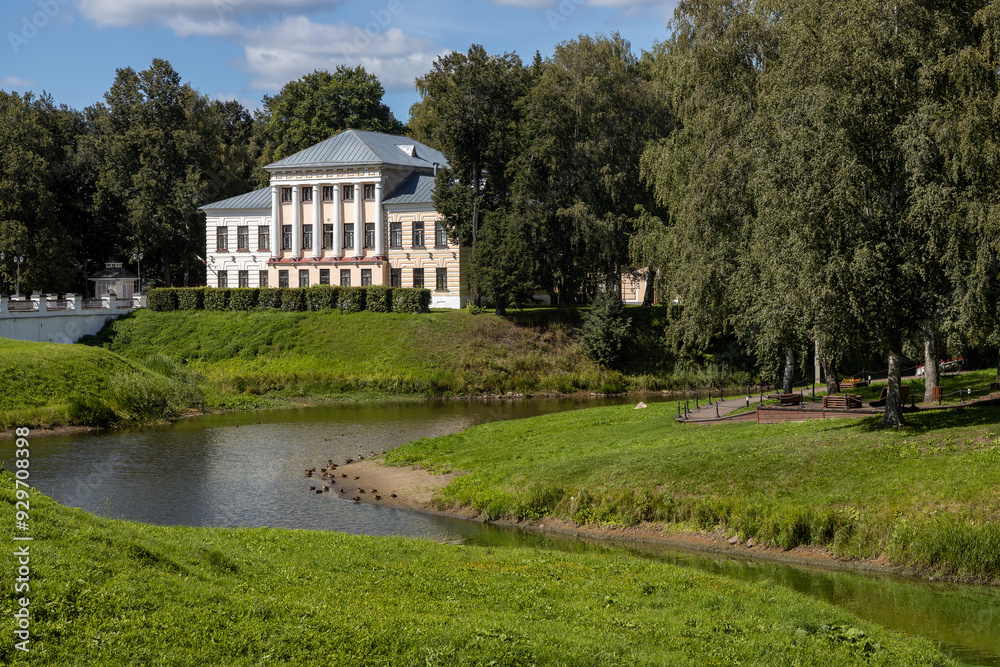 Former City Duma in Uglich, a historic building in classicist style, nestled in greenery by the serene waters of the Kremlin Park Former City Duma in Uglich, a historic building in classicist style, nestled in greenery by the serene waters of the Kremlin Park