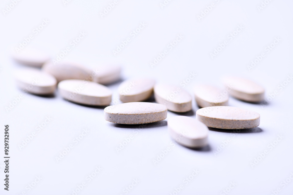Ashwagandha (Withania somnifera) tablets. Concept for a healthy dietary supplementation. Bright paper background. Close up. Copy space. Ashwagandha (Withania somnifera) tablets. Concept for a healthy dietary supplementation. Bright paper background. Close up. Copy space.