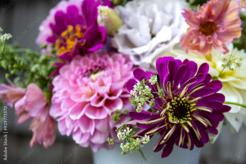 Close-up of vibrant bouquet with pink and purple flowers in white vase Close-up of vibrant bouquet with pink and purple flowers in white vase