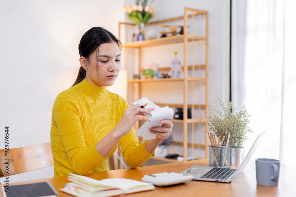 Stressed young asian woman calculating monthly home expenses, tax, bank account balance and credit card bills payment, Income is not enough for expenses. Stressed young asian woman calculating monthly home expenses, tax, bank account balance and credit card bills payment, Income is not enough for expenses.