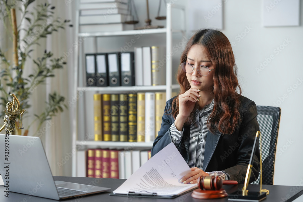 Lawyer working in office is carefully reviewing legal documents, with a ...