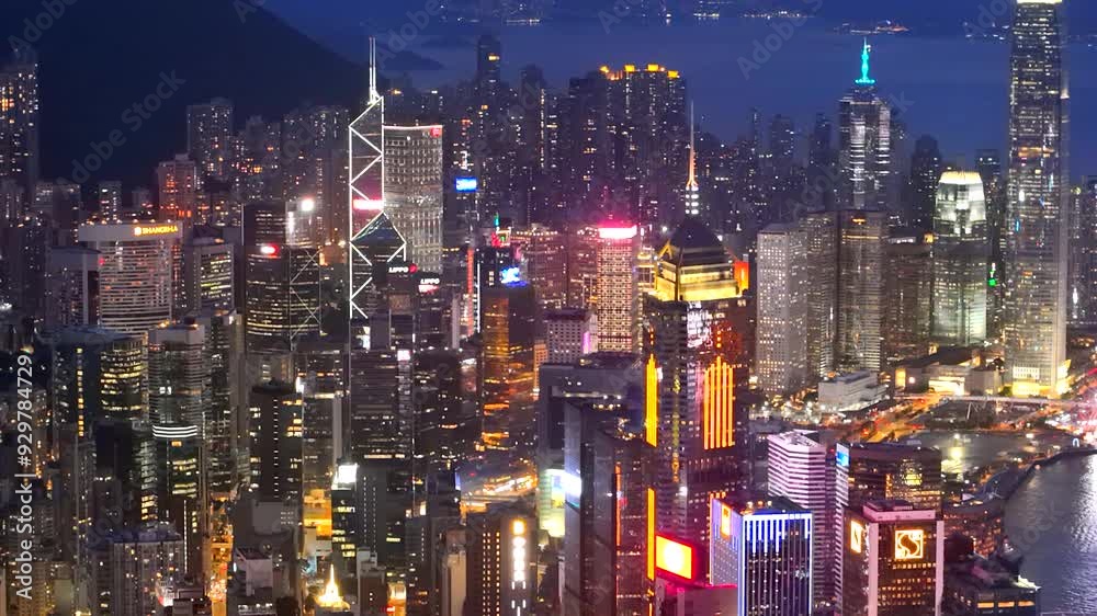Aerial view drone video City landscape of the famous travel landmark cityscape. buildings with light and transportation at Victoria Harbour skyline and Kowloon at sunset along Hong Kong Island China. Aerial view drone video City landscape of the famous travel landmark cityscape. buildings with light and transportation at Victoria Harbour skyline and Kowloon at sunset along Hong Kong Island China.