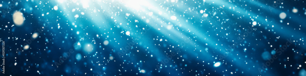 Naklejka premium Underwater light rays illuminate sparkling particles in a serene aquatic environment
