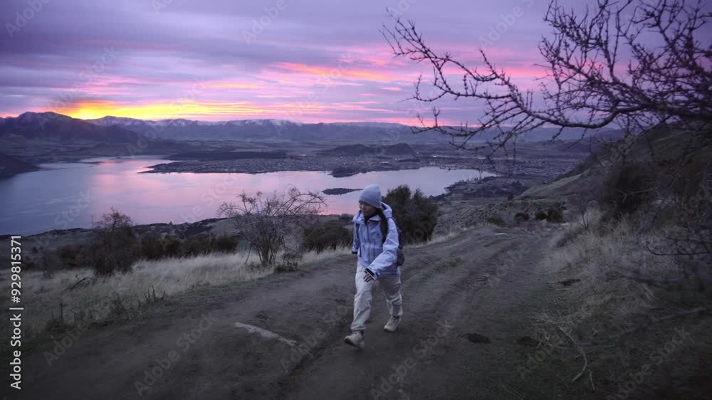 Female Hiker At Roys Peak Route In Wanaka Lakefront In New Zealand. Slow Motion Shot Female Hiker At Roys Peak Route In Wanaka Lakefront In New Zealand. Slow Motion Shot