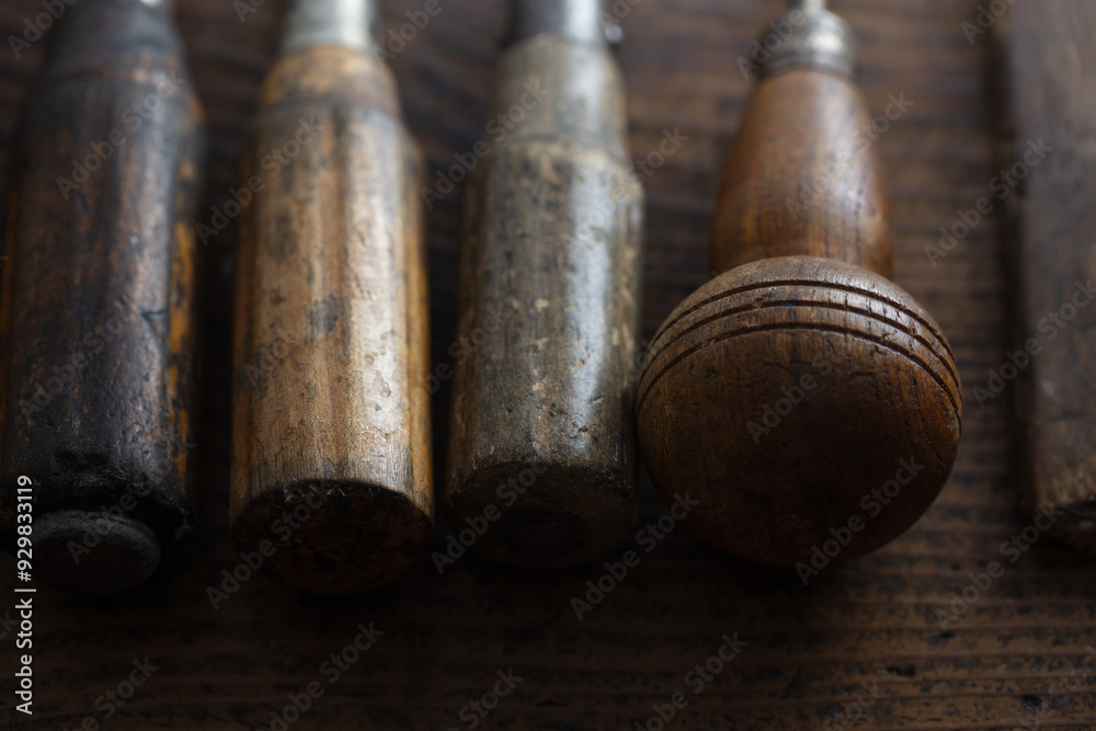 Old, well used, aged wooden handles of tools. on a rustic wooden table. Old, well used, aged wooden handles of tools. on a rustic wooden table.