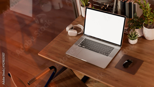 A top view image of a laptop computer mockup on a wooden table in a cozy contemporary room.