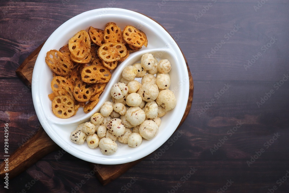 Crispy lotus stem chips and roasted makhana, perfectly spiced and golden brown, offer a delightful crunch and unique flavor. Ideal for healthy snacking or as a gourmet appetizer. kurkuri Kamal kakdi. Crispy lotus stem chips and roasted makhana, perfectly spiced and golden brown, offer a delightful crunch and unique flavor. Ideal for healthy snacking or as a gourmet appetizer. kurkuri Kamal kakdi.
