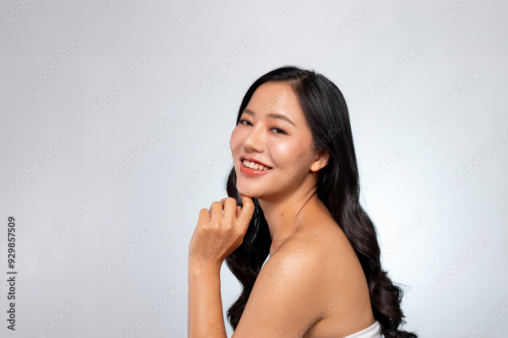 A young, beautiful Asian woman poses with her hand on her chin, smiling with her teeth visible. A young, beautiful Asian woman poses with her hand on her chin, smiling with her teeth visible.