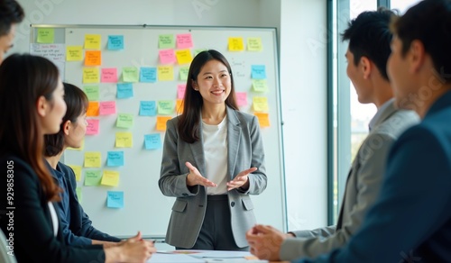 Young Asian Businesswoman Presenting Creative Ideas During a Collaborative Team Meeting