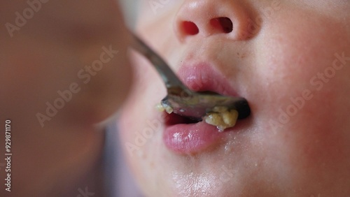 Wallpaper Mural grimy baby eats from a spoon close-up of the lips. happy family kid dream concept. baby close-up eats with a dirty spoon. baby opens mouth eats lifestyle mashed potatoes from a spoon Torontodigital.ca