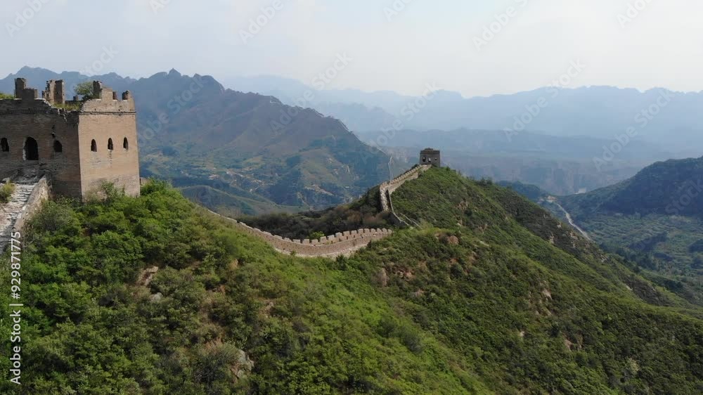 Cinematic drone shot over the Great Wall of China, the footage captures a tower and goes over the gorgeous mountains. Scene captured on a foggy day with incredible landscapes Cinematic drone shot over the Great Wall of China, the footage captures a tower and goes over the gorgeous mountains. Scene captured on a foggy day with incredible landscapes