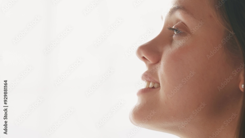 girl on a white background looks to the side. beauty dream concept. woman closes her eyes she dreams. the girl lifestyle smiles, shows her teeth, she thinks about her wonderful future girl on a white background looks to the side. beauty dream concept. woman closes her eyes she dreams. the girl lifestyle smiles, shows her teeth, she thinks about her wonderful future
