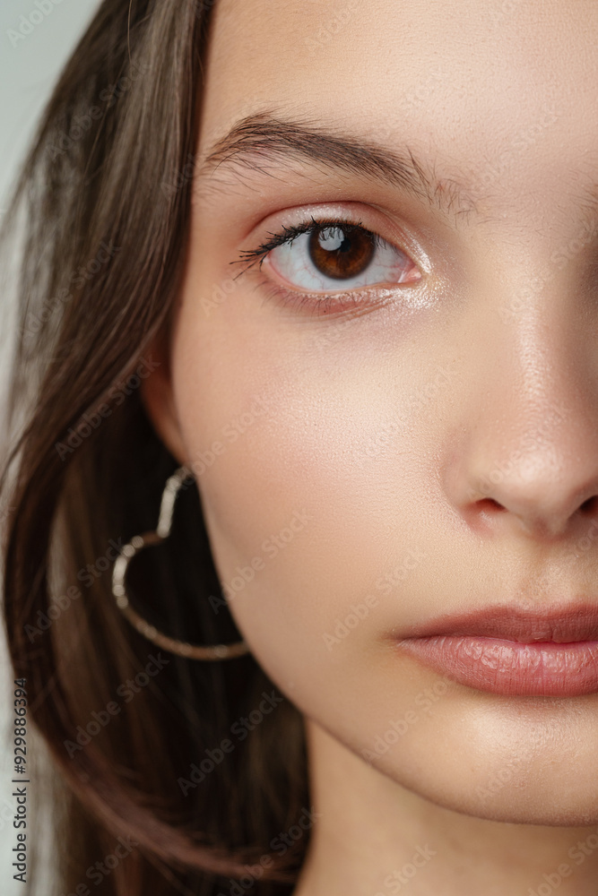 Obraz premium Close Up of a Woman's Face With Brown Eyes