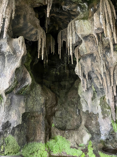 Geological cave with natural erosion in the rock and stalactites photo