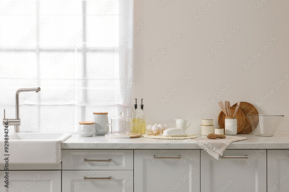 Fototapeta premium Stylish kitchen interior with beige wall. Space for text