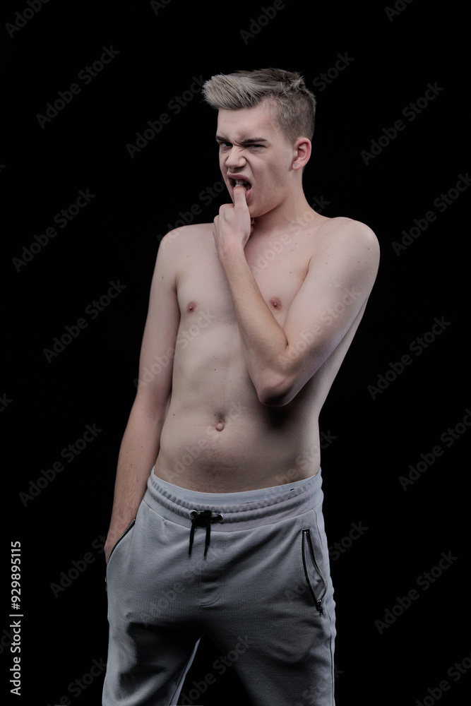 Fototapeta premium Young man posing in the dark in the studio
