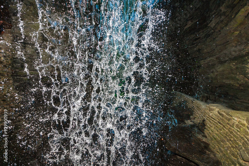 A waterfall falls into a pool among rock formations at Watkins Glen State Park in Pennsylvania, showcasing the power and beauty of nature, USA photo