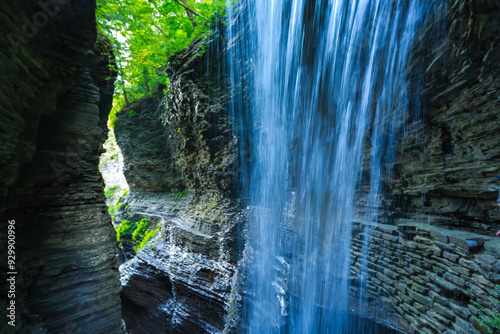 Fototapeta Naklejka Na Ścianę i Meble -  A waterfall falls into a pool among rock formations at Watkins Glen State Park in Pennsylvania, showcasing the power and beauty of nature, USA
