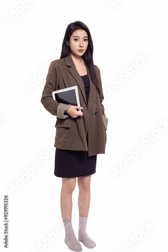 Sweet oriental woman in suit and skirt in front of white background