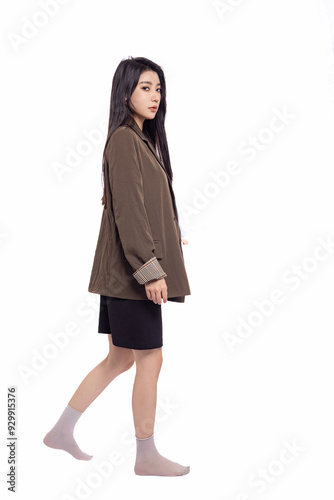 Young beautiful oriental woman in suit in front of white background White background