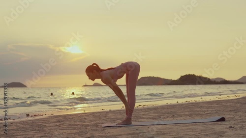 Young Asian woman practicing yoga pose on the beach at sunset.concept for Yoga Sport and Healthy lifestyle