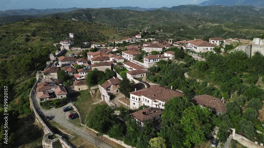 Aerial view of Albanian city Berat with view of castle walls and tiled roofs of houses. Aerial view of Albanian city Berat with view of castle walls and tiled roofs of houses.