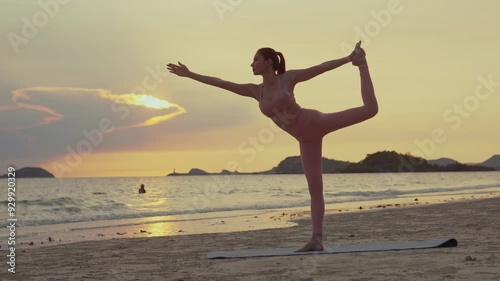 Young Asian woman practicing yoga pose on the beach at sunset.concept for Yoga Sport and Healthy lifestyle