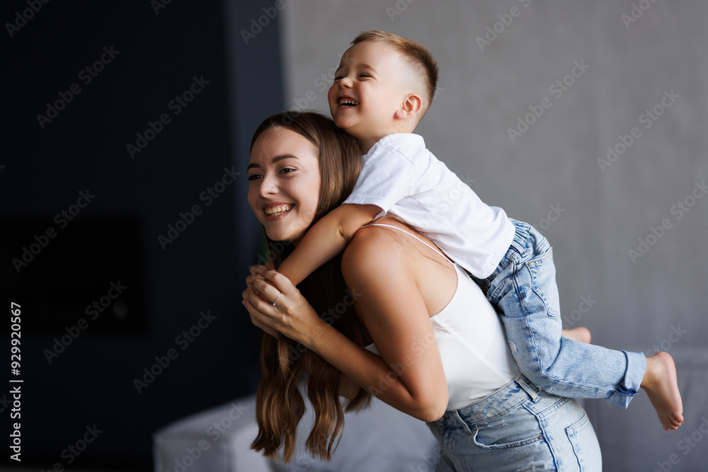 Mother playing with toddler child on the couch. Parent having fun with toddler infant boy. Mother playing with toddler child on the couch. Parent having fun with toddler infant boy.