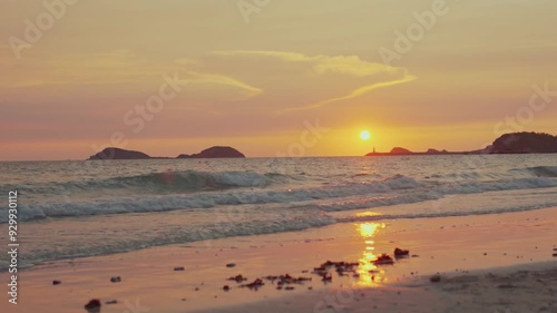 Sand and Waves on sunset beach.