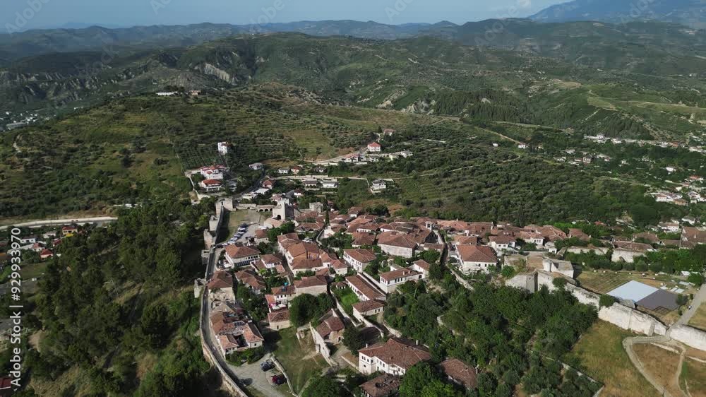 Aerial view of Albanian city Berat with view of castle walls and tiled roofs of houses. Aerial view of Albanian city Berat with view of castle walls and tiled roofs of houses.