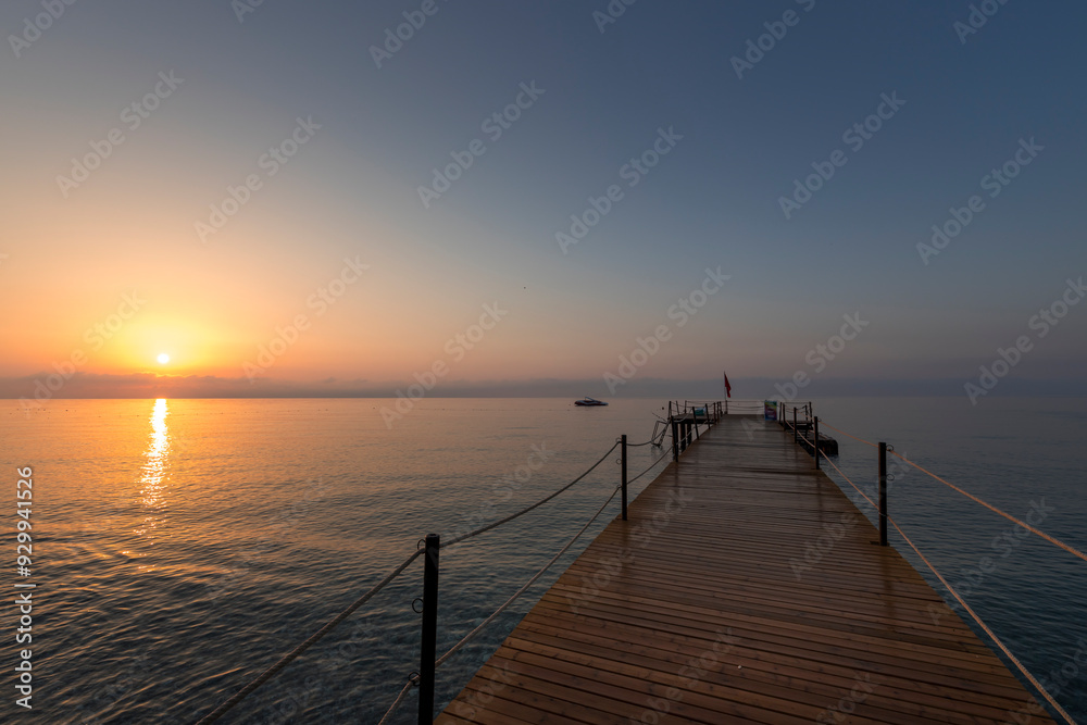 A pier with a dock and a boat in the water A pier with a dock and a boat in the water