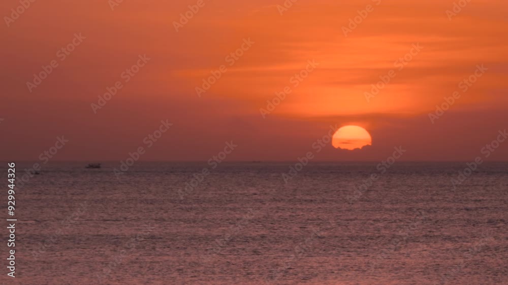 Stunning Sunset By The Sea At Jimbaran Beach In South Kuta, Bali, Indonesia. wide shot Stunning Sunset By The Sea At Jimbaran Beach In South Kuta, Bali, Indonesia. wide shot