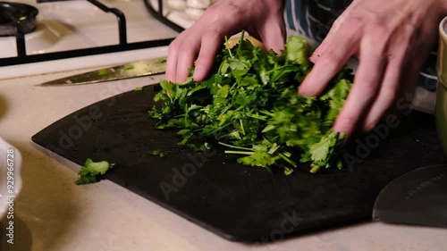 Fresh parsley and cilantro, chopped.  4k video, close angle, vertical video