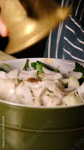 A male chef pours freshly ground spices into a falafel mixture, vertical video, 4k video, close up