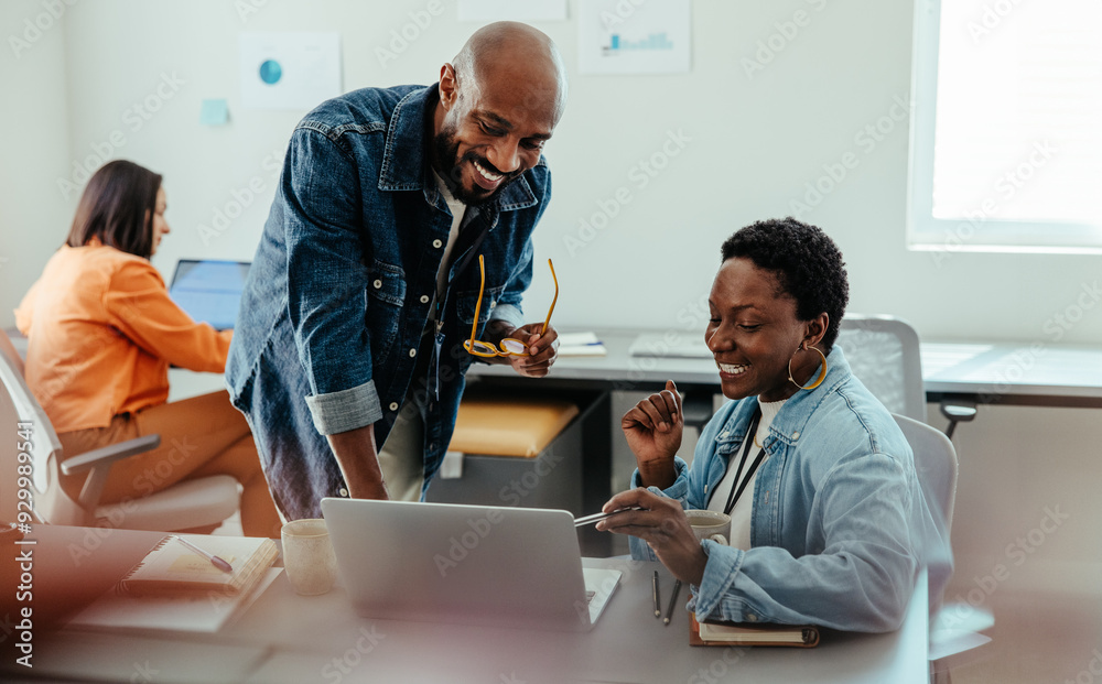 Manager giving feedback and collaborating with an employee during a review discussion in a modern office Manager giving feedback and collaborating with an employee during a review discussion in a modern office