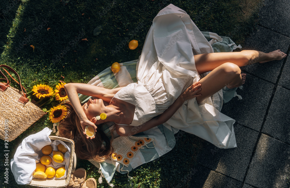 photo in Italian style with a sexy young woman in a light summer dress a peasant woman picking fruits