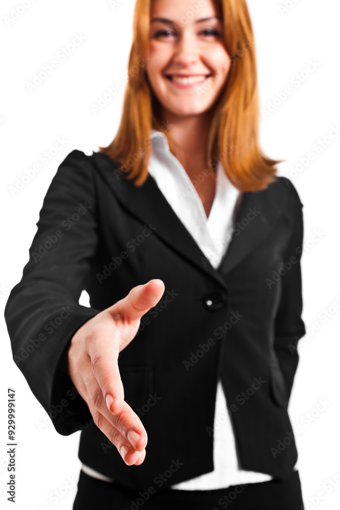 Confident young businesswoman extends her hand in a handshake ge Confident young businesswoman extends her hand in a handshake ge