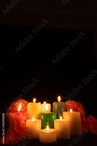 Cuadro en lienzo Lit candles surrounded by marigolds are arranged centrally, casting a gentle lig